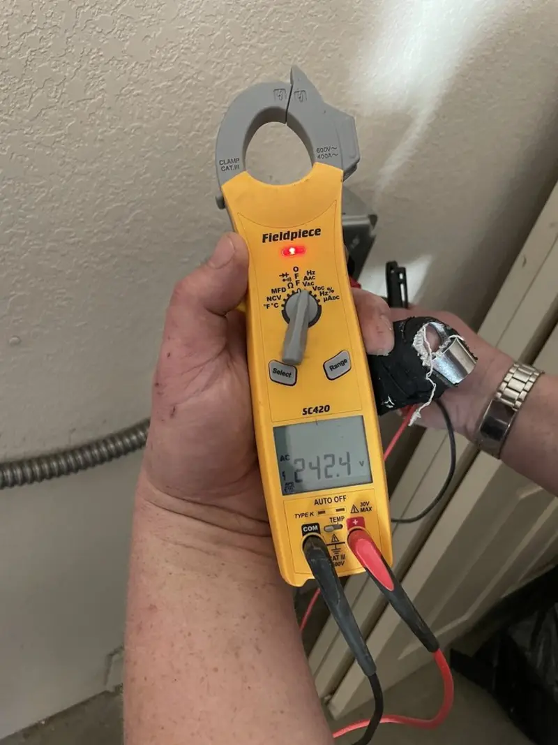 Voltage testing with clamp meter during Electrical Installation Services in Nassau